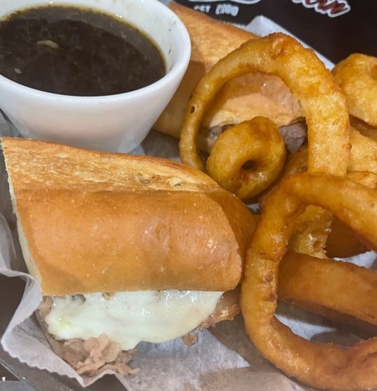Experience a symphony of flavors! Tender deli-sliced roast beef, paired with gooey provolone and luscious cream cheese, on a soft hoagie roll. Served with our aromatic garlic au jus for an unforgettable dipping experience.