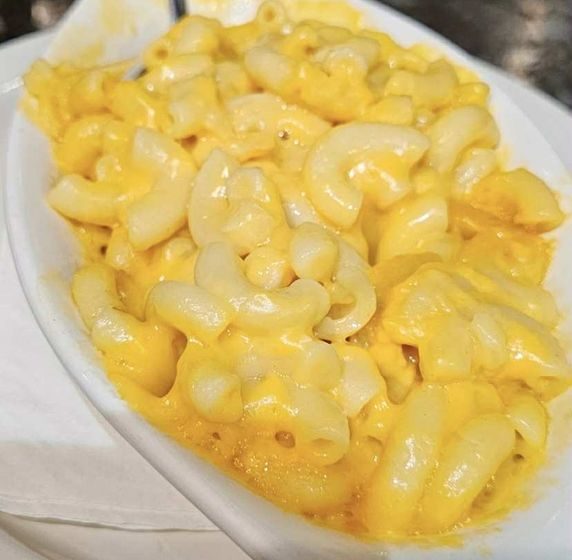 Indulge in a side of our creamy, comforting baked macaroni and cheese, made with that signature goodness and a golden, bubbly top. Pure cheesy perfection
