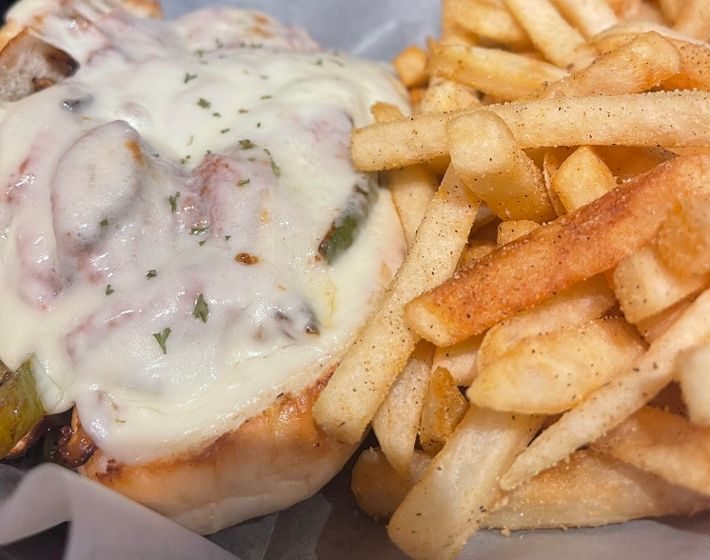 Indulge in thinly sliced turkey breast, perfectly complemented by sweet sautéed onions and peppers, all smothered in creamy white American cheese. A warm, hearty, and delicious experience.