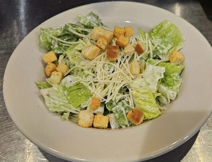 Our timeless Caesar salad features crisp romaine lettuce, generously tossed with shredded Parmesan cheese and crunchy croutons. Served with our creamy Caesar dressing on the side, so you can add just the right amount to every bite!